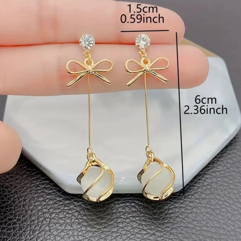 Elegant Gold and White Drop Earrings. Christmas ball and bow earrings.